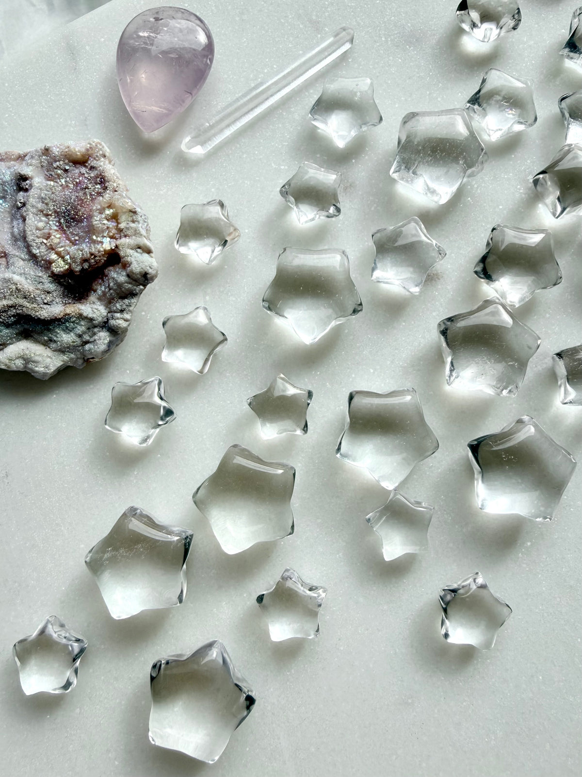 Natural Clear Quartz crystal stars arranged with other gemstones, miniature celestial carvings for crystal grids, moon rituals and altar decor