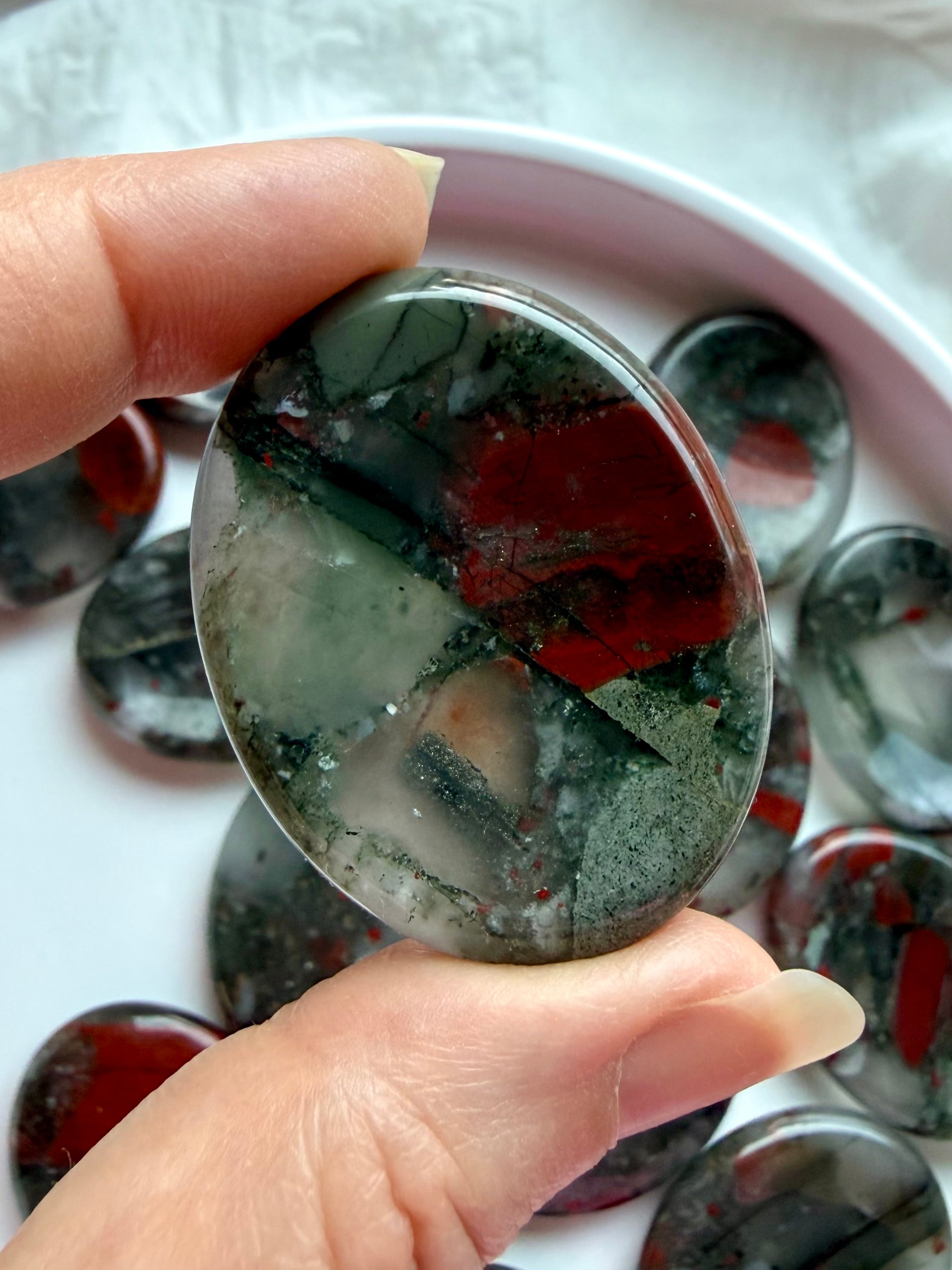 Bloodstone worry stone with deep green and red patterns, Root Chakra crystal for strength, stability, and protection