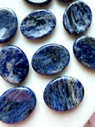 Sodalite thumb stones displayed together showing unique blue and white marbling, calming pocket crystals for everyday use