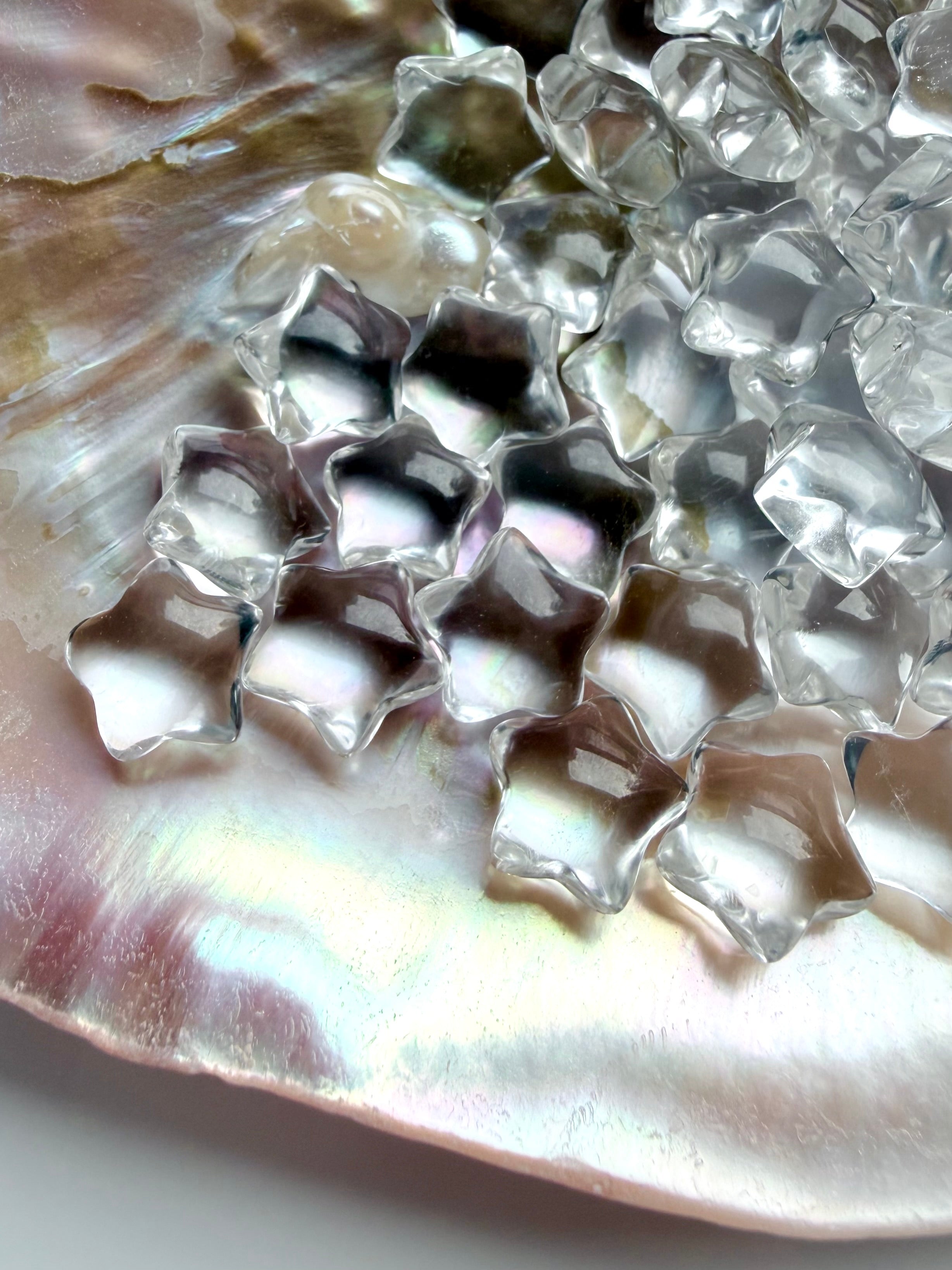 Collection of miniature Clear Quartz stars with sparkling reflections and natural inclusions, tiny healing crystals for meditation and manifestation