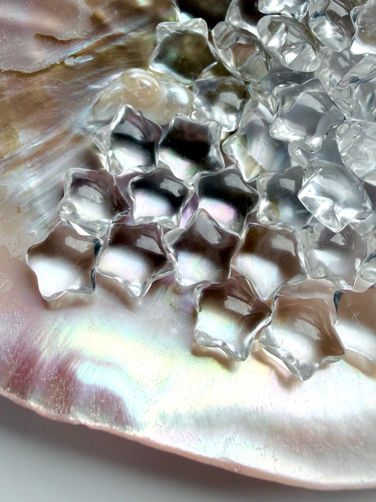 Collection of miniature Clear Quartz stars with sparkling reflections and natural inclusions, tiny healing crystals for meditation and manifestation