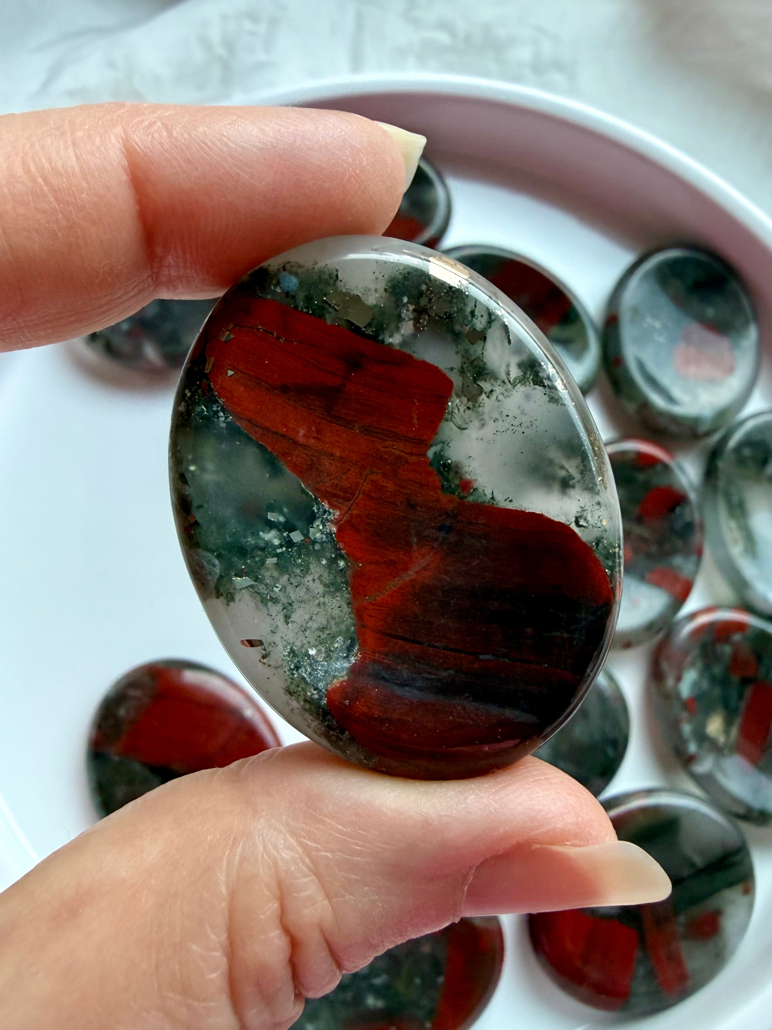 Natural Bloodstone oval thumb stone with bold red formations and smoky green coloring, crystal for grounding and protection