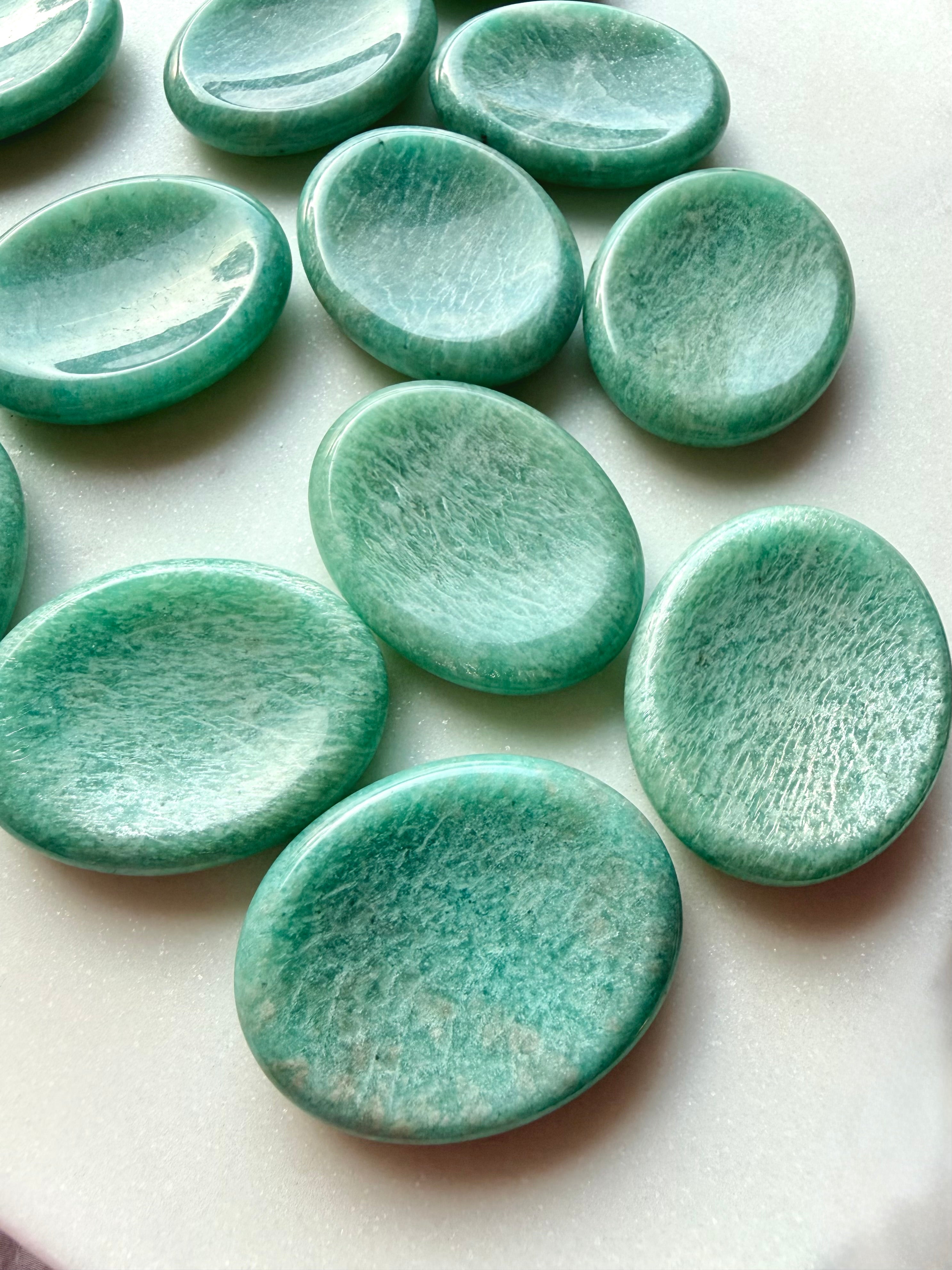 Polished Amazonite worry stones arranged together, calming green healing crystals for stress relief, meditation and emotional balance