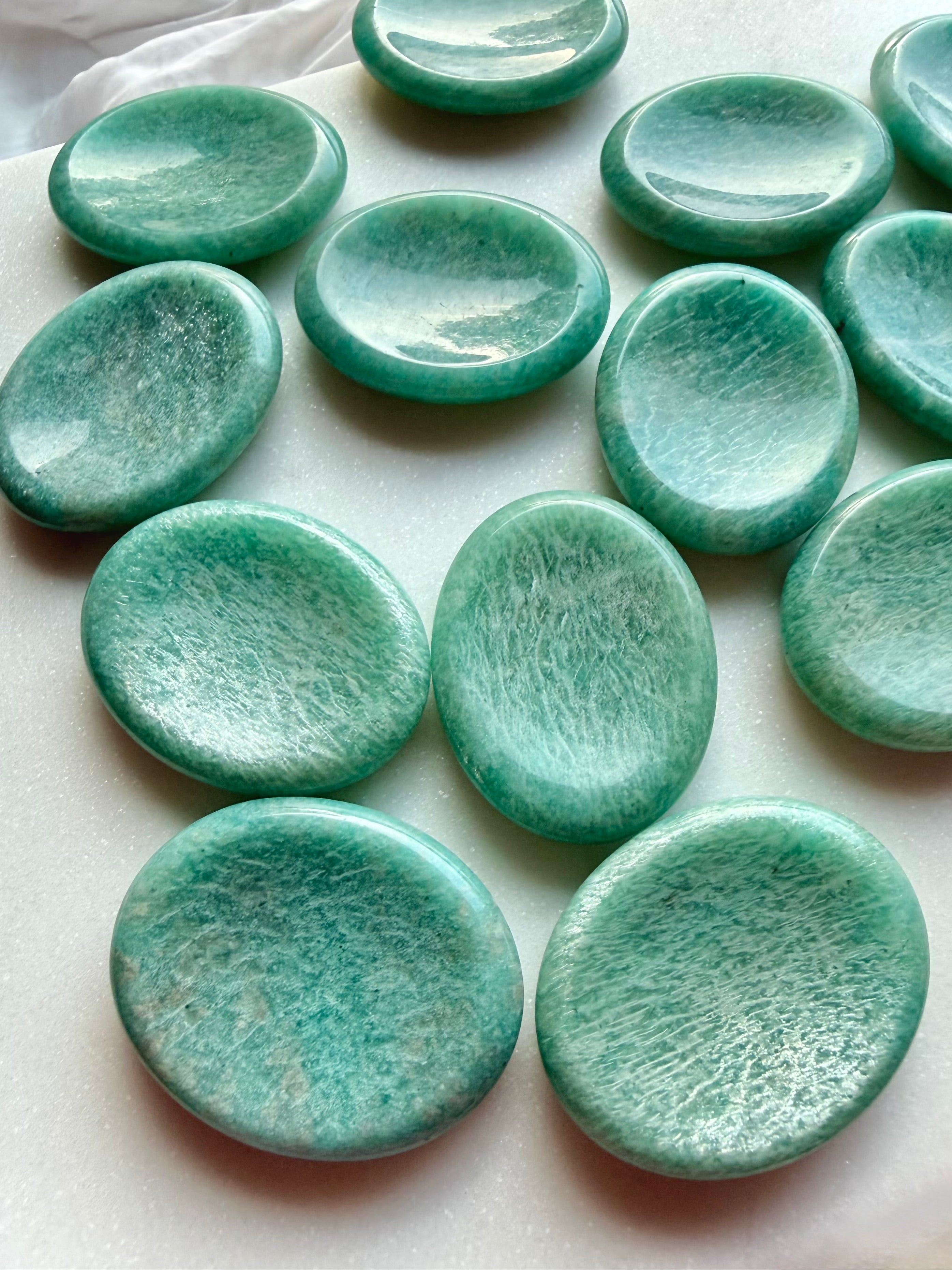 Collection of natural Amazonite worry stones with smooth thumb grooves, polished green gemstones for mindfulness and relaxation