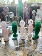 An array of crystal goddess statues shown within a crystal collection bring Divine Feminine energy