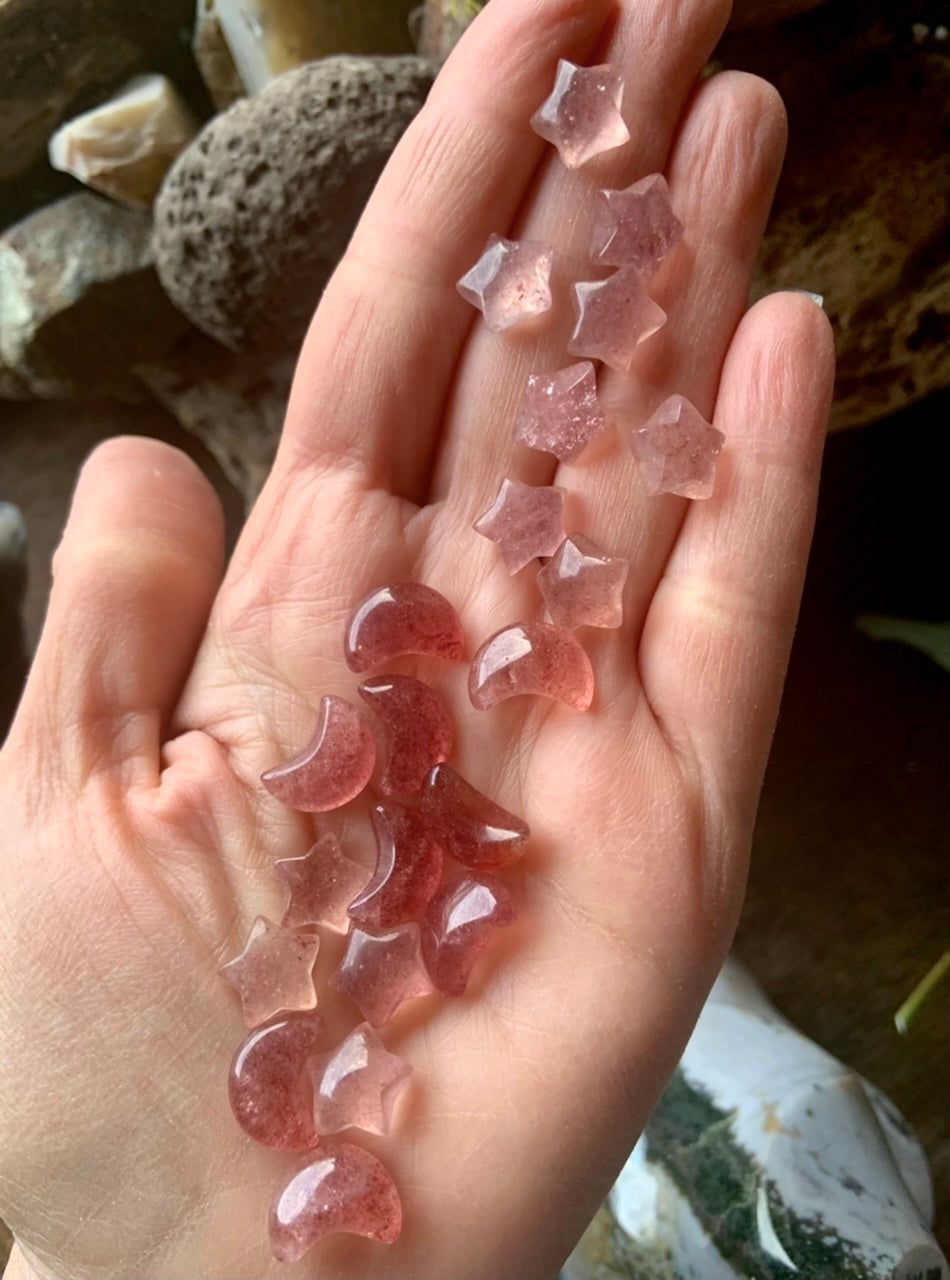 Strawberry Quartz moon and star carvings shown on hand — mini tanzberry crystals for heart chakra healing, love, and emotional balance