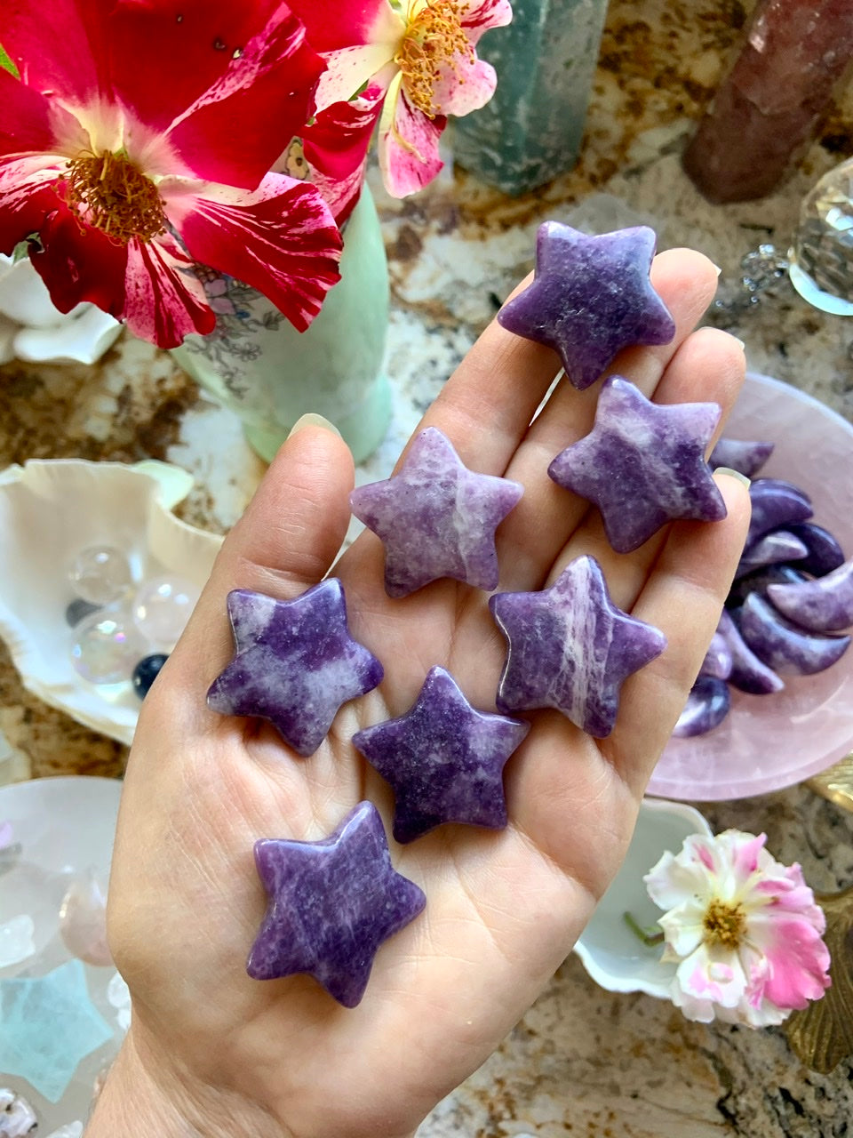 Purple Lepidolite CStar shaped crystal carvings shown on my hand for scale