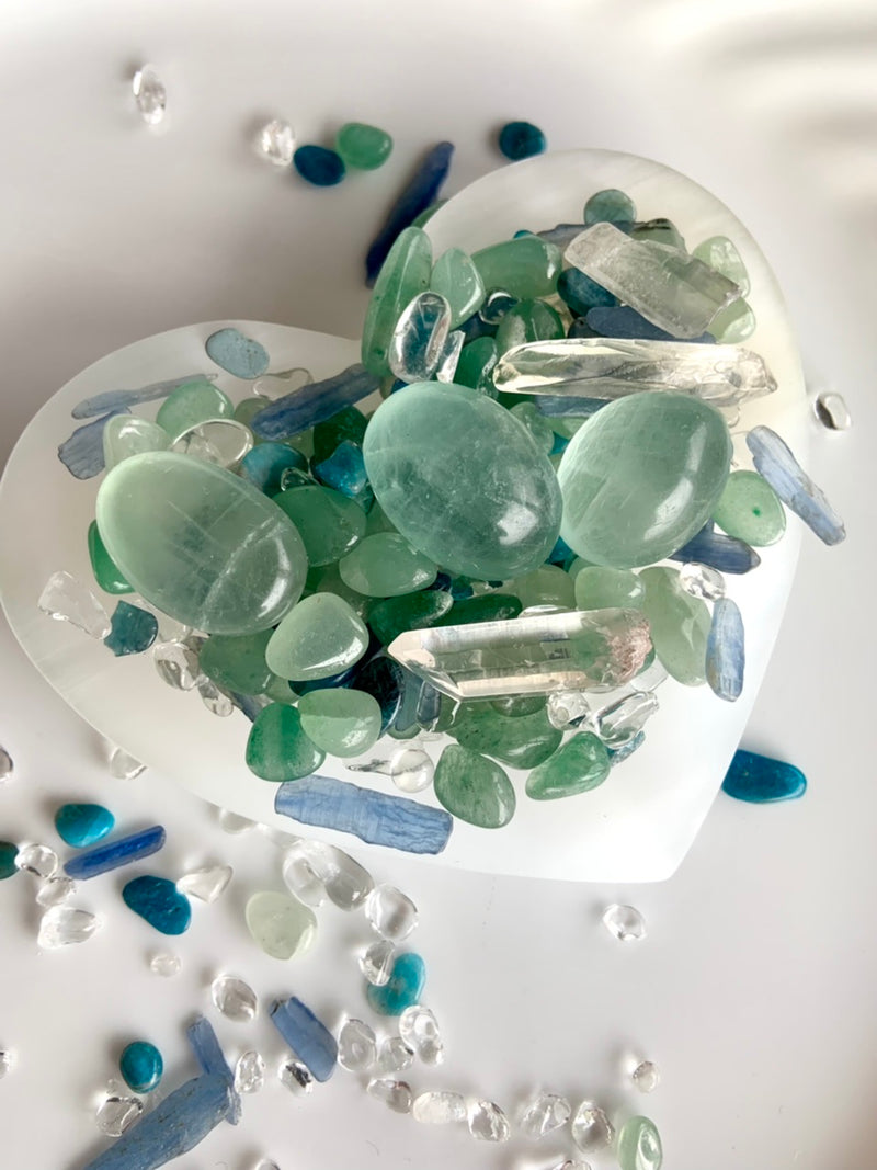 Our Blue Green Mermaid Crystal Confetti with fluorite tumbles and clear quartz points shown in a white bowl