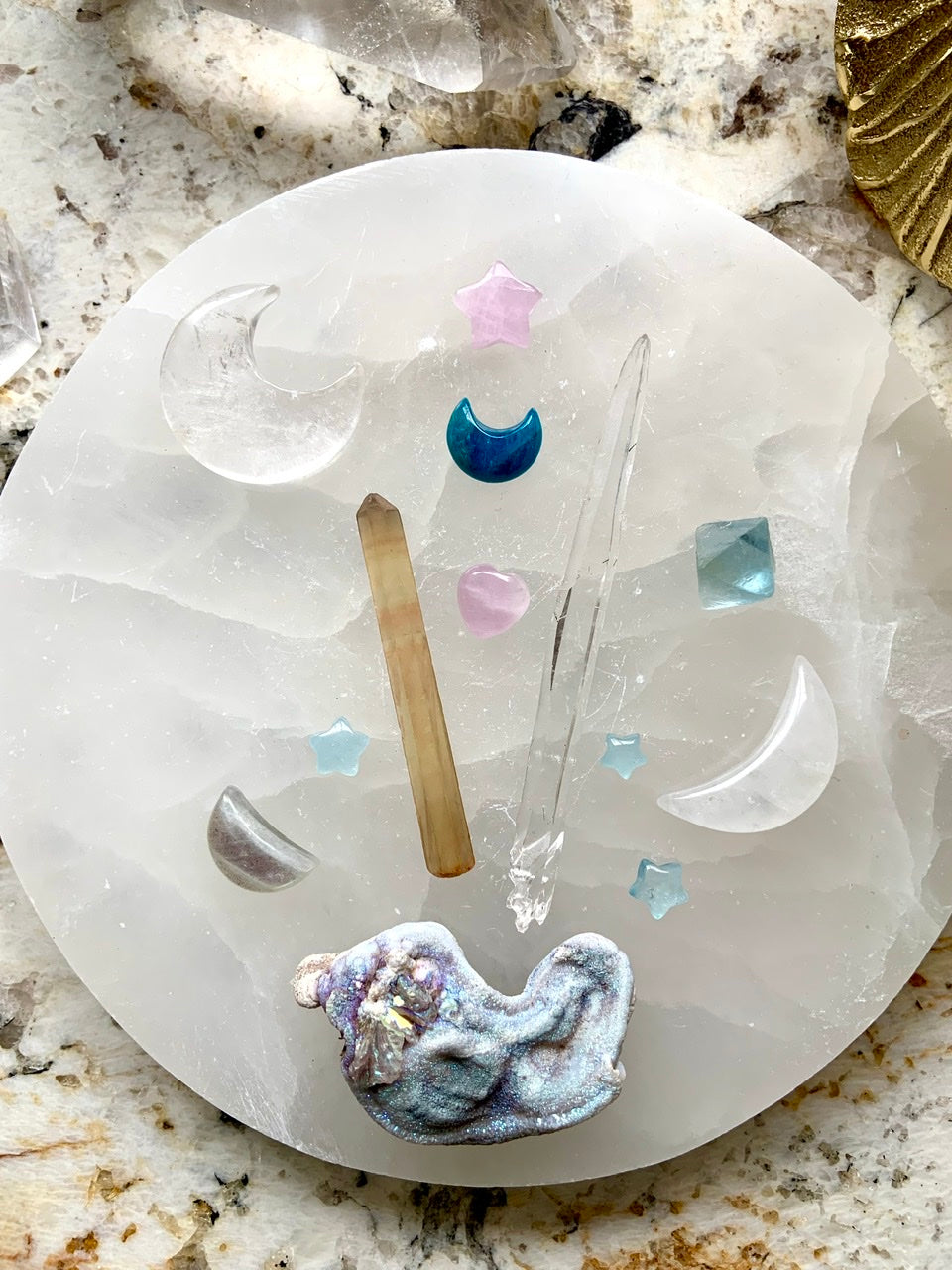 Celestial crystal grid with quartz moons, quartz points & aura druzy on a selenite plate — sacred energy setup featuring Blue Apatite for clear communication & healing.