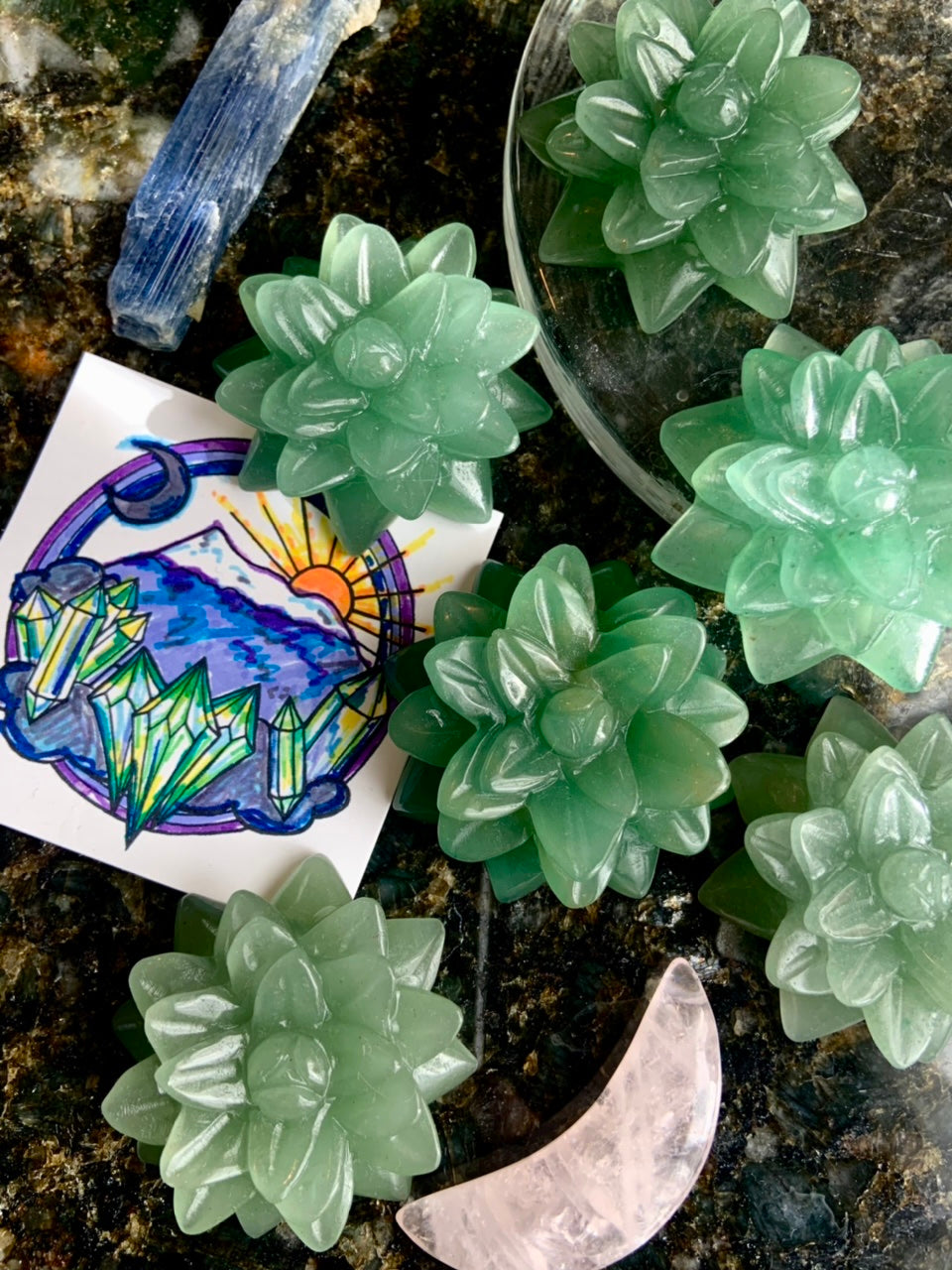 Multiple Green Aventurine crystal succulents with a crystal moon & Wild Mountain Crystals logo card — green crystal carvings for chakra healing & crystal décor.