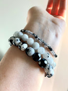 Mixed bracelet stack featuring 10–11mm Orca Agate beads paired with Rainbow Moonstone and Black Tourmaline in Quartz crystal bracelets