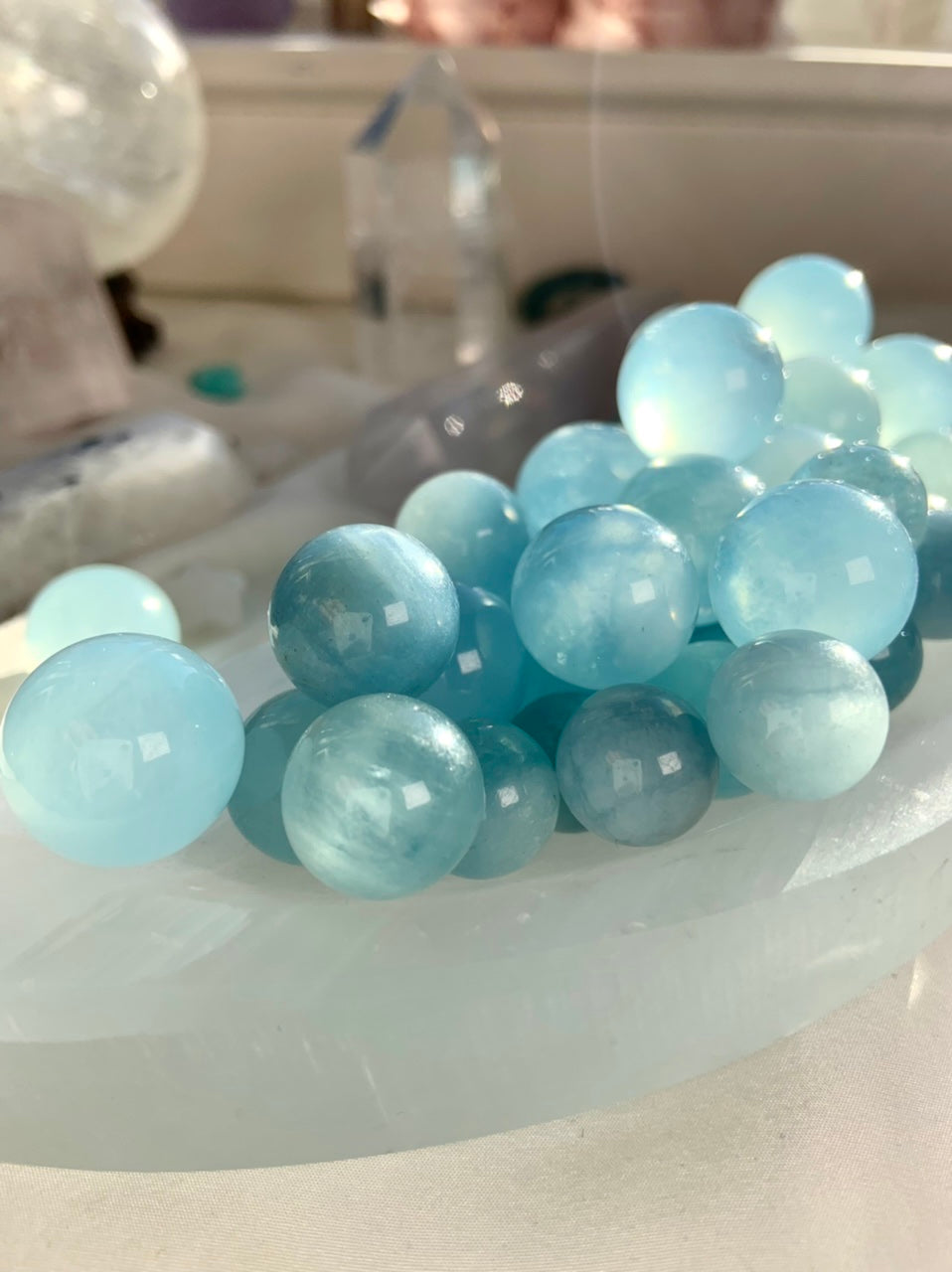 Aquamarine mini crystal spheres arranged in crescent shape – blue March birthstone spheres