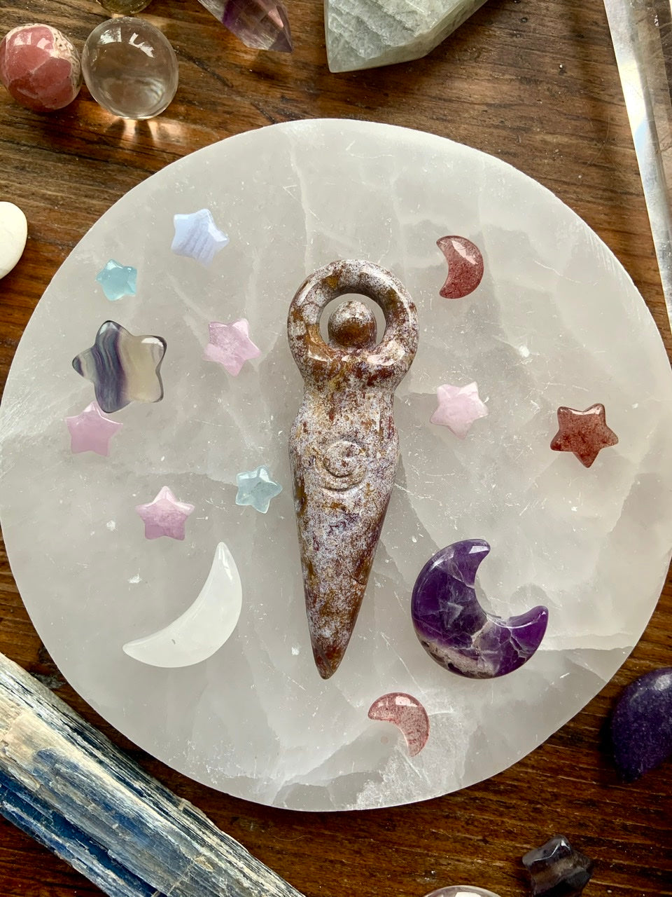 Crystal goddess carving on selenite plate with mini stars and moons in Kunzite, Fluorite, Amethyst, and Quartz — celestial altar grid for divine feminine energy and chakra healing