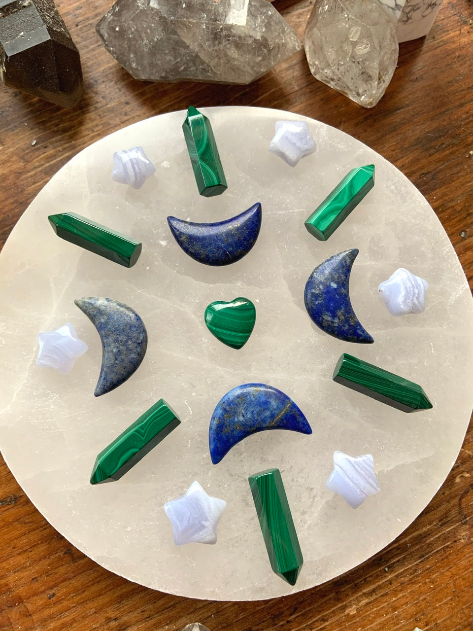 Blue Lace Agate stars in a crystal grid with Malachite points & Lapis Lazuli moons on a selenite plate — high-vibe tools for clarity, balance & expression.