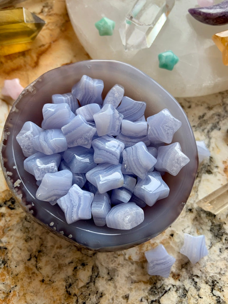 A bowl of blue lace agate stars to show the variety in the unique lace patterns in this natural agate, some even have a quartz layer