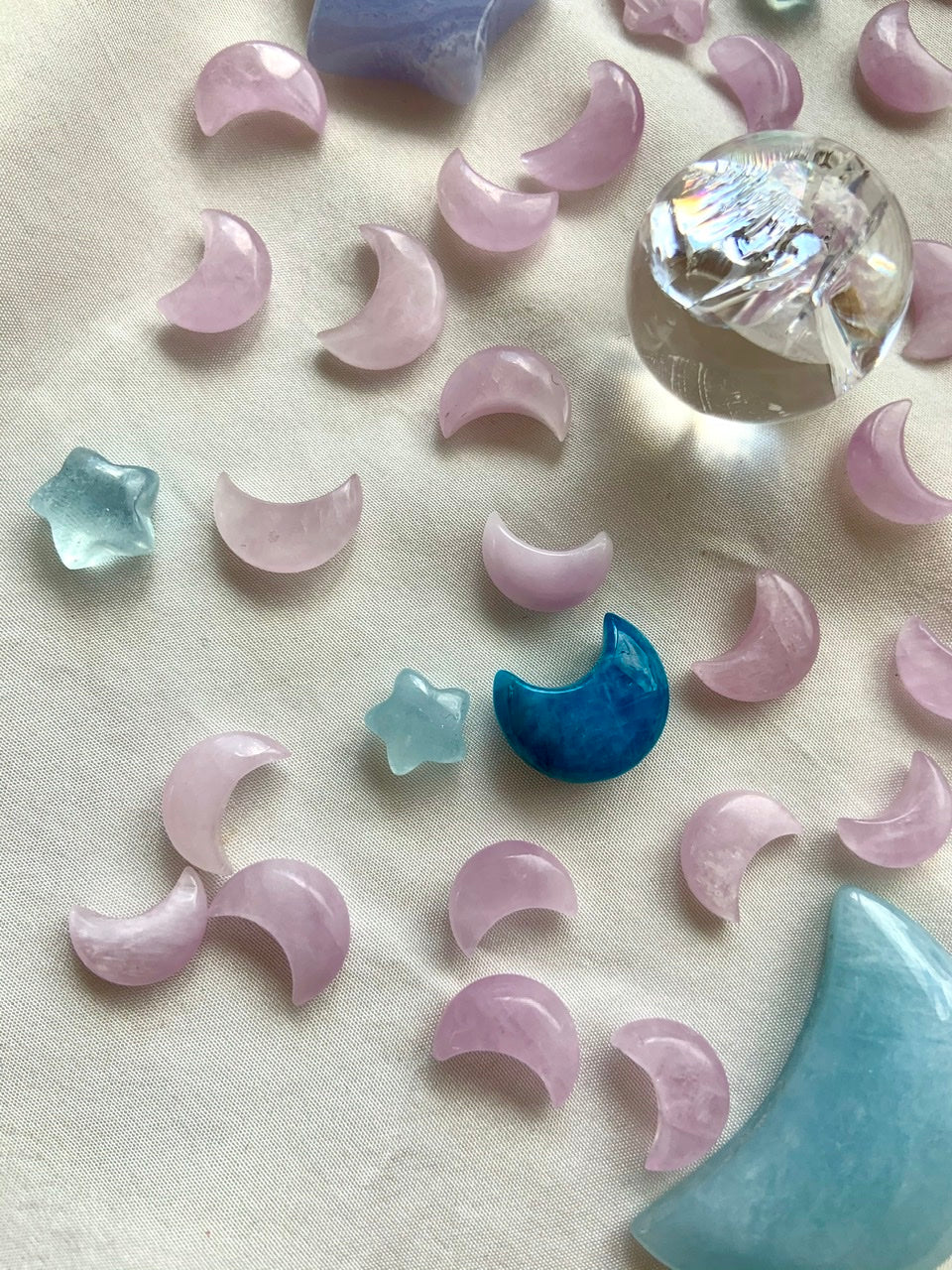 Mini Kunzite moons with celestial crystal carvings & aura quartz sphere — sacred tools for crystal grids, altars & spiritual intention.