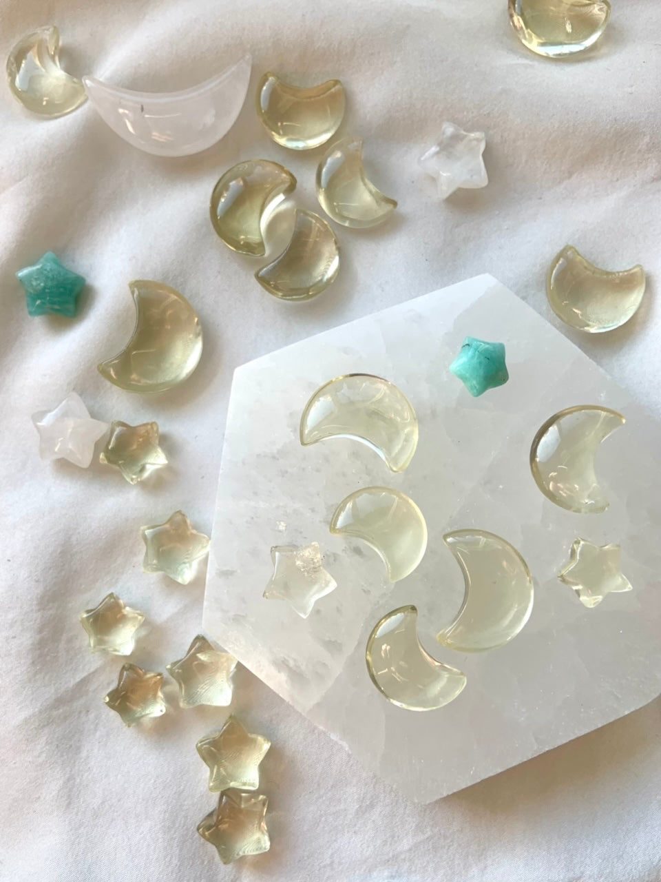Mini lemon citrine moons and stars on a hexagonal selenite plate with celestial crystal accents — joyful mini crystals for abundance and solar energy