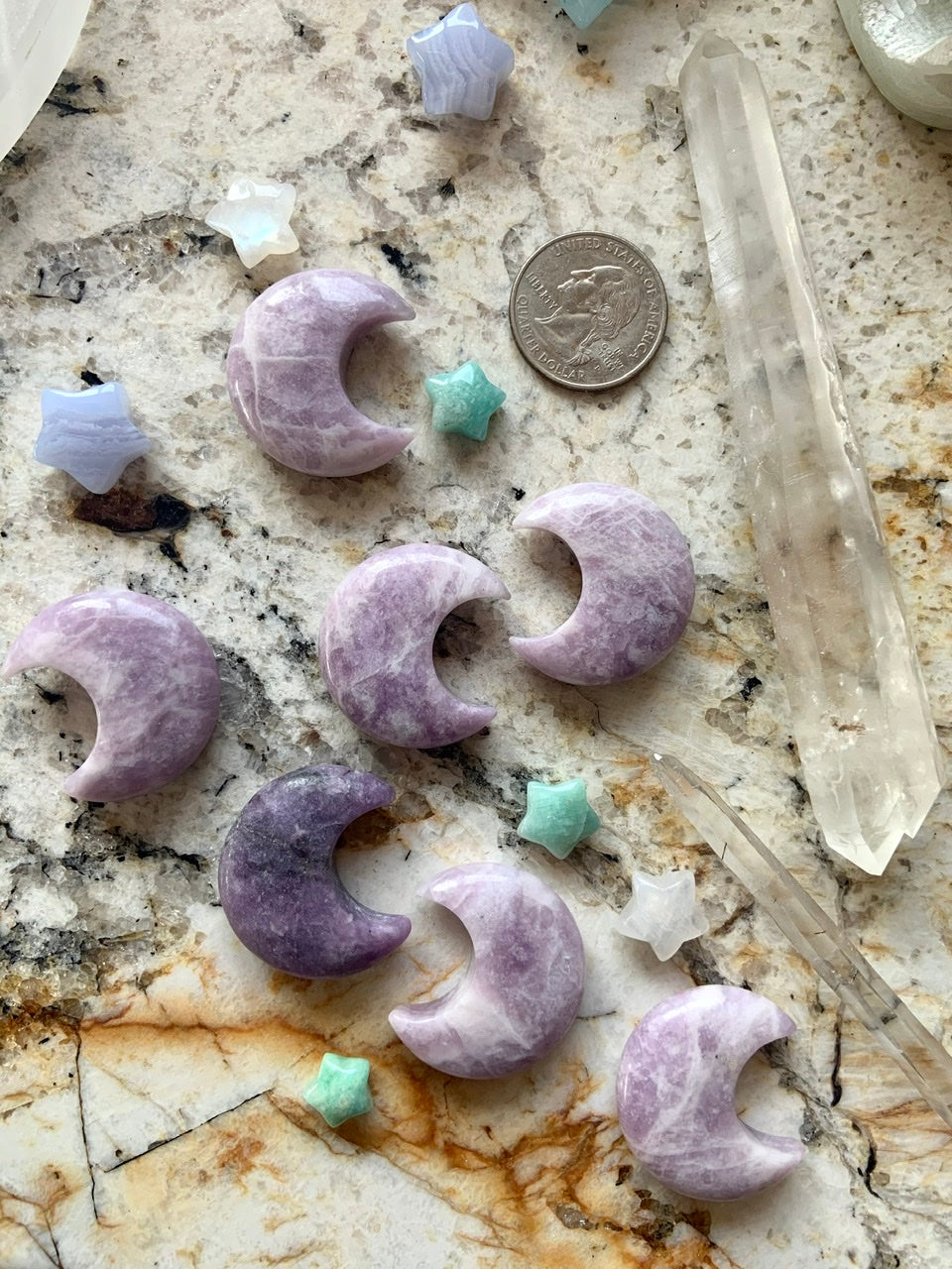 lilac lepidolite moon and star crystals shown with quarter for size reference and scale comparison