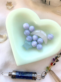 tiny blue lace agate spheres shown in a heart shaped bowl with other mini crystals