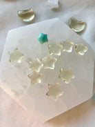 Mini citrine star carvings on a selenite plate with Amazonite — crystal stars for joy, clarity, and Solar Plexus chakra energy