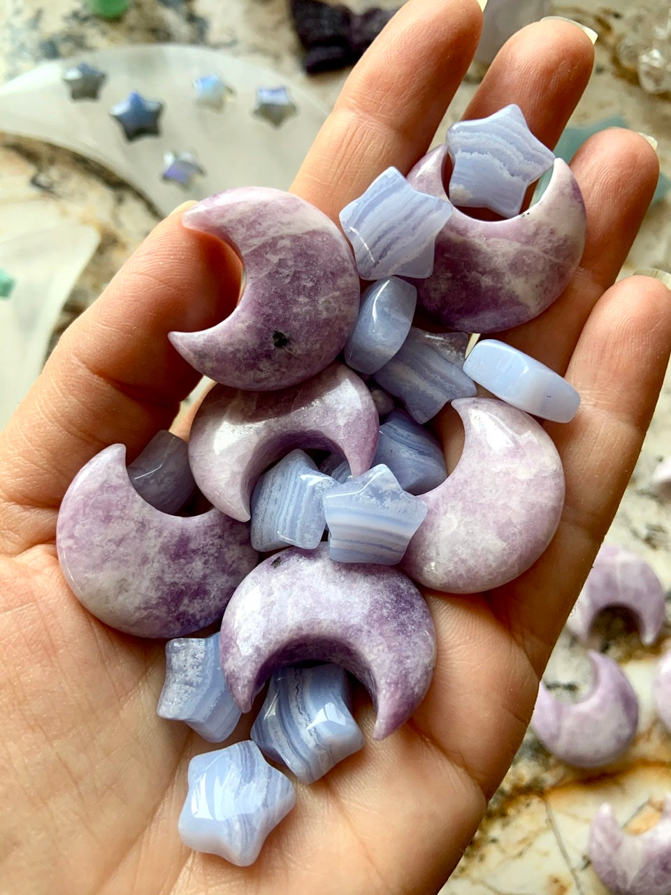 Mini Blue Lace Agate stars in hand with Lepidolite moons — gentle healing crystals for emotional balance & clear communication.