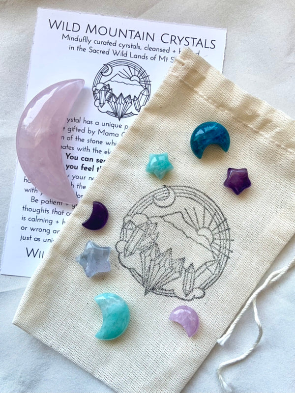 Mini Crystal Moon and Star Set of colorful celestial crystals inside a carrying pouch hand stamped with the Wild Mountain Crystals logo + info to help you ID the stones + learn to work with their crystal healing properties.