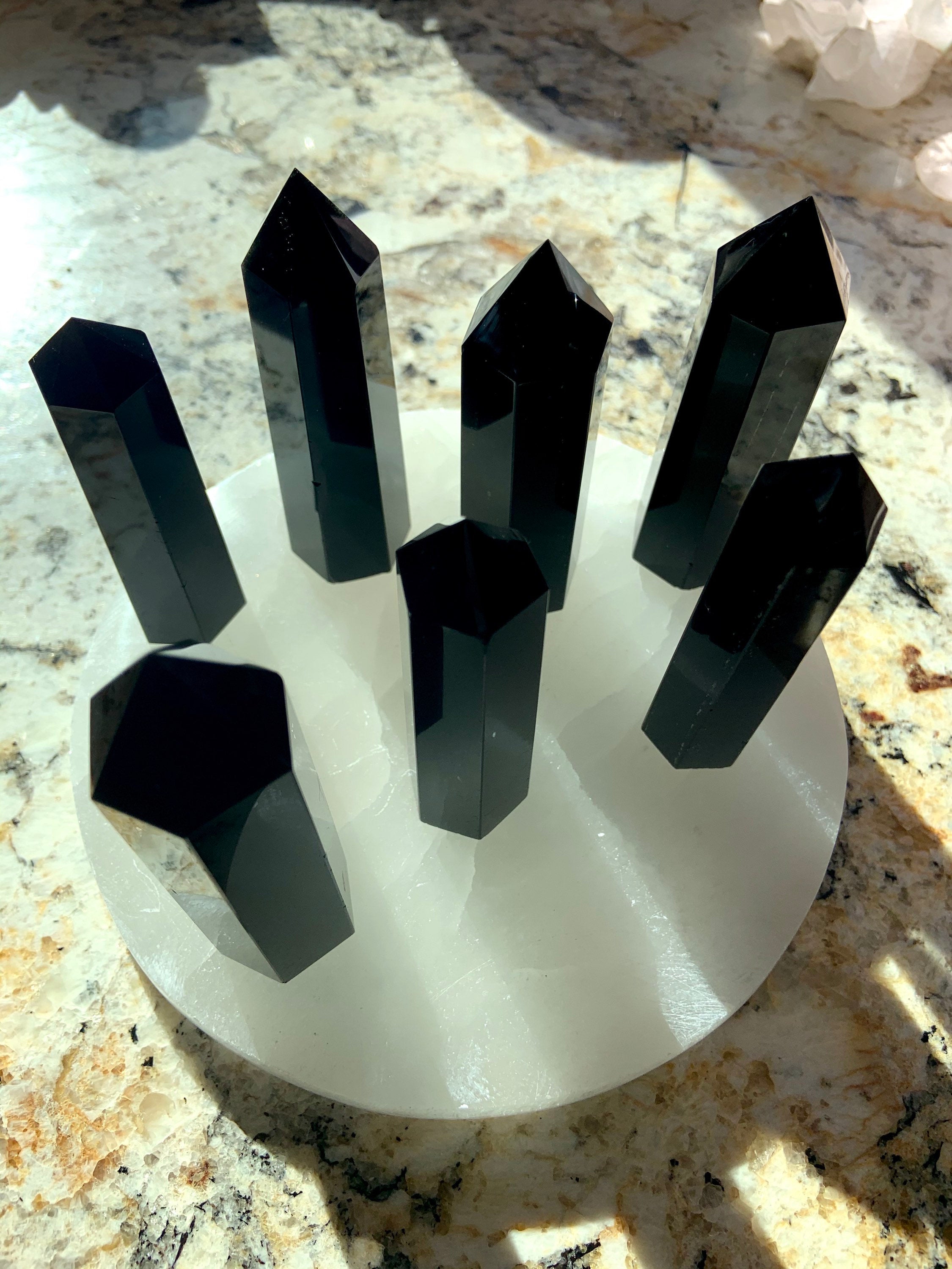 An array of black obsidian towers in the sunlight
