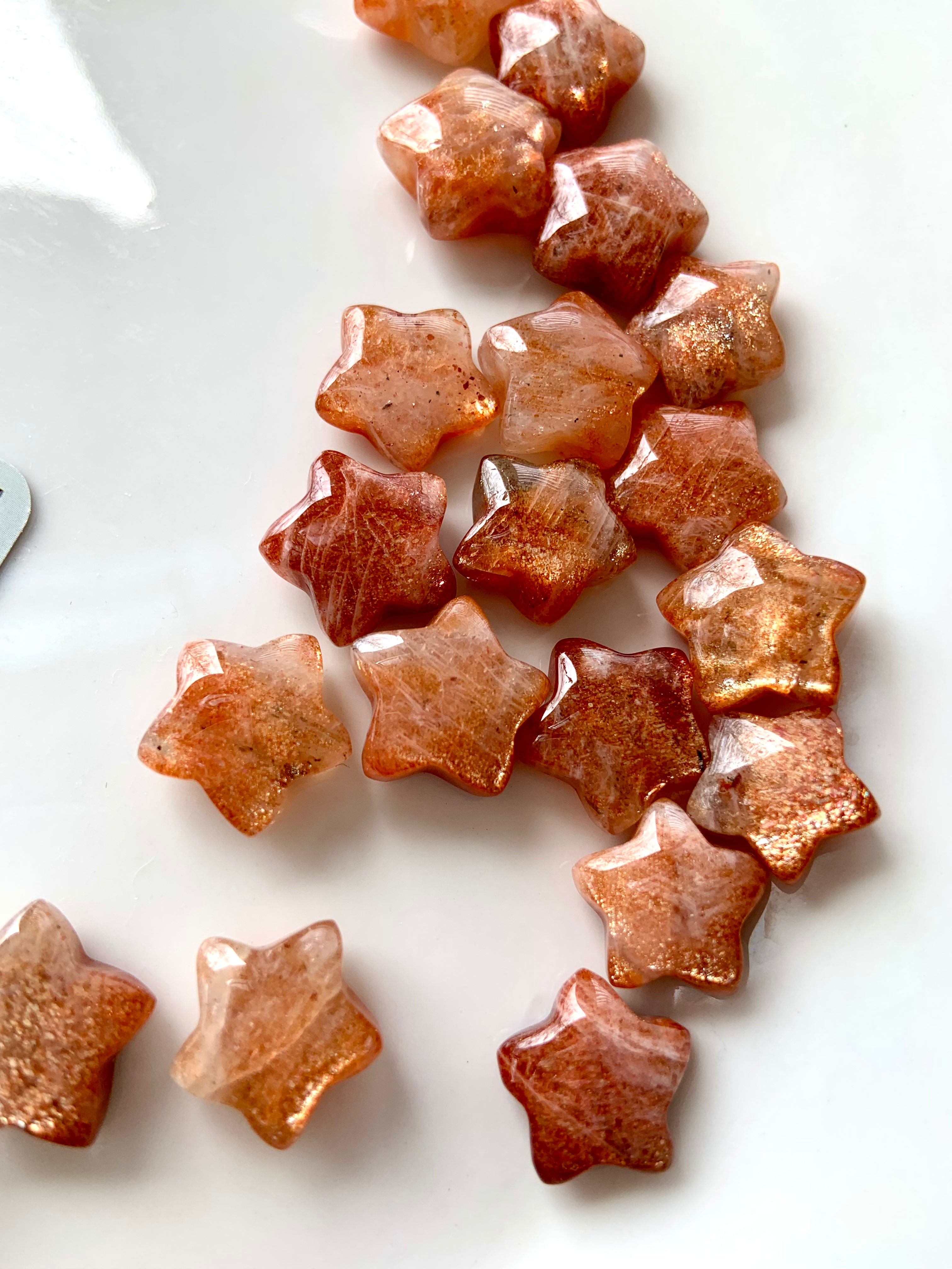 Sparkly Arusha Sunstone stars with confetti and lattice inclusions — crystal star carvings for joy, confidence, and Solar Plexus chakra healing