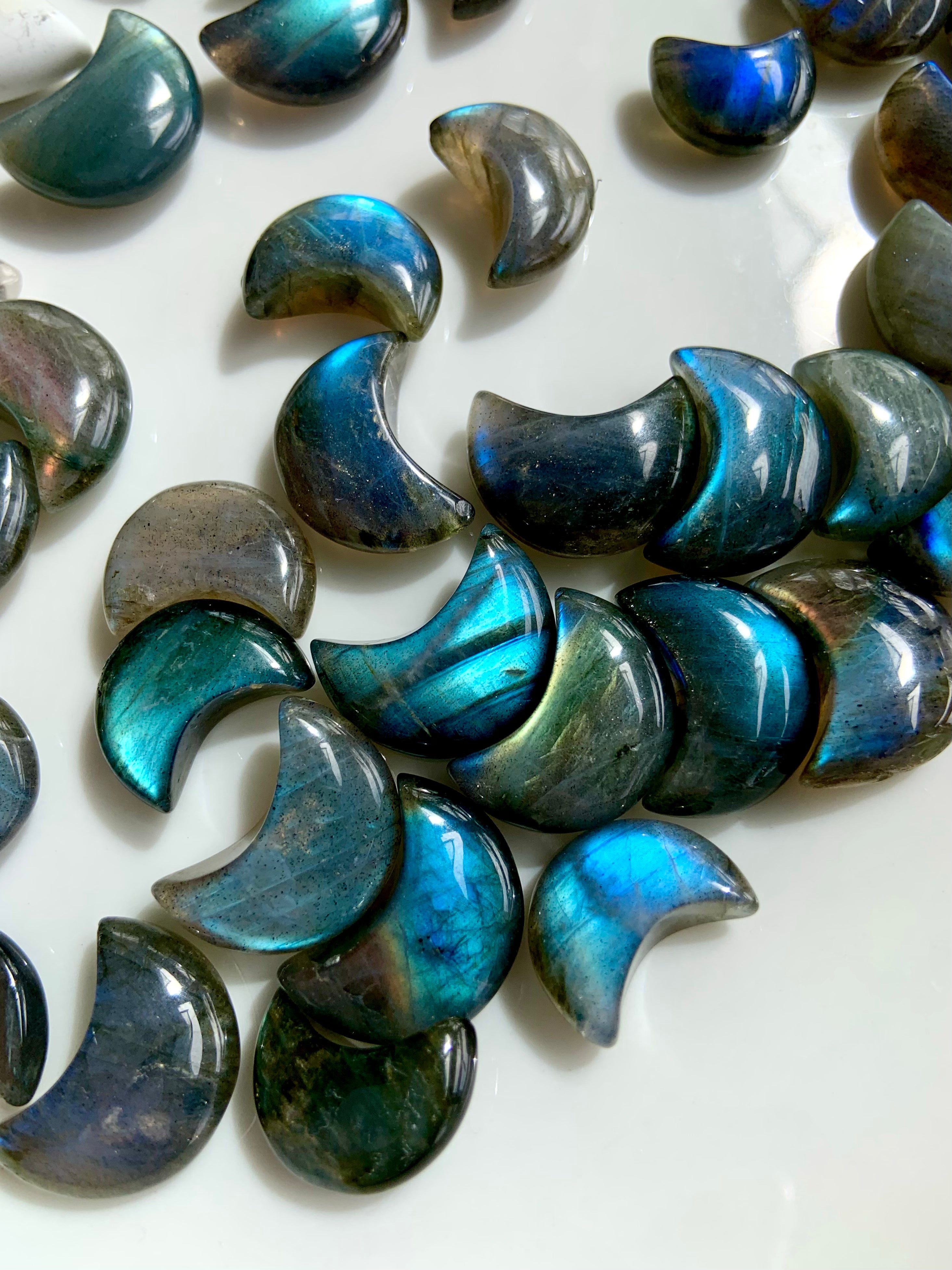Close-up of deep blue Labradorite moons showing color variation and iridescent flash — mystical Third Eye stones for spiritual vision.