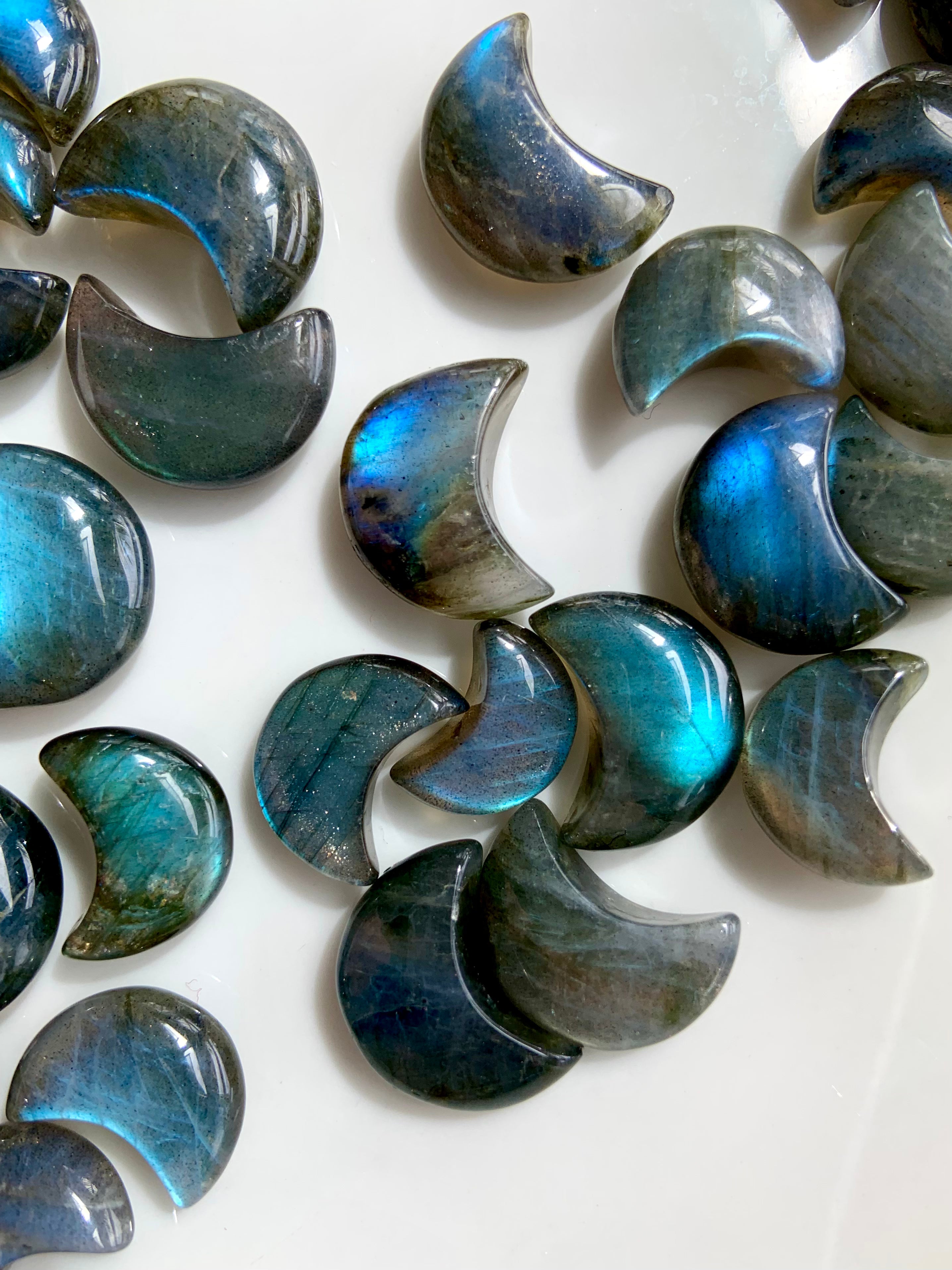 Close-up of Labradorite crescent moons highlighting blue flash, shape, and natural patterning — Third Eye crystals for intuition & insight.